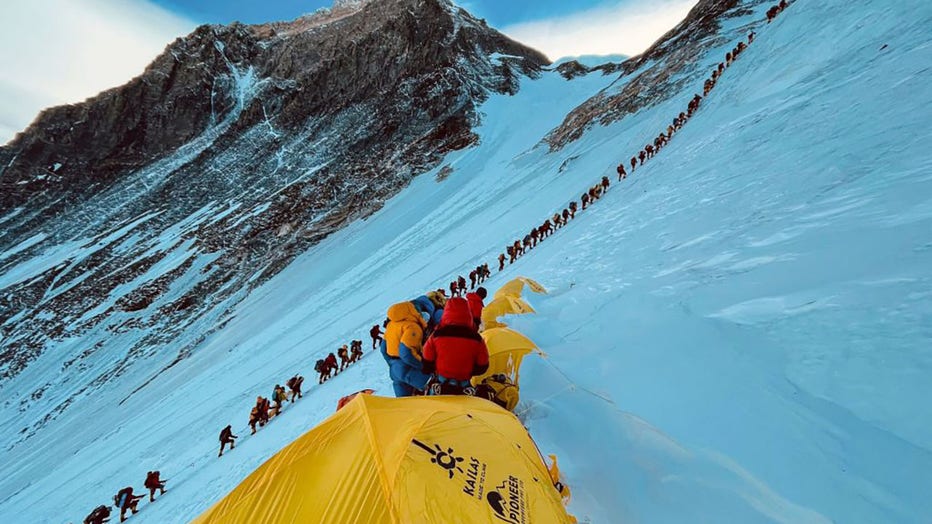 This photograph taken on May 31, 2021, shows mountaineers lined up as they climb a slope during their ascend to summit Mount Everest (8,848.86-metre), in Nepal. (Photo by LAKPA SHERPA/AFP via Getty Images)