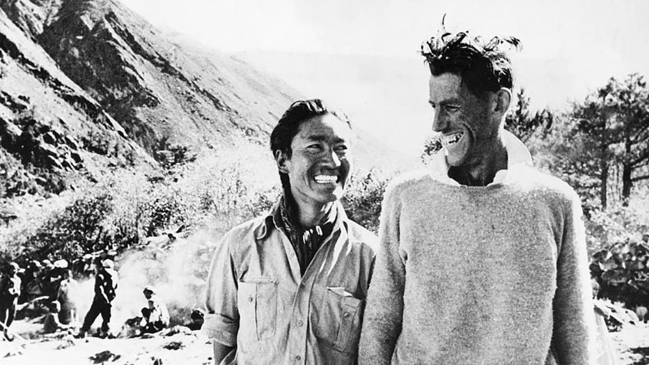 (Original Caption) First conquerors of Mount Everest: Smiling victors Sherpa Tenzing (Left) and Edmund Hillary at their camp after their return from Everest, circa June 1953.