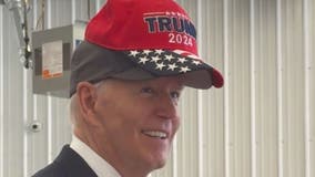 'No eating dogs and cats,' Biden jokes as he wears Trump 2024 hat