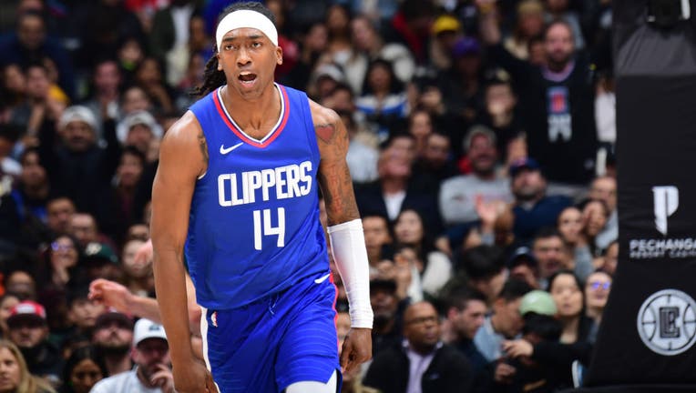 Terance Mann #14 of the LA Clippers celebrates during the game against the Sacramento Kings on December 12, 2023 at Crypto.Com Arena in Los Angeles, California. (Photo by Adam Pantozzi/NBAE via Getty Images)