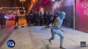 Man covered in blue paint runs away from cops in Los Angeles