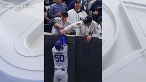 Fans try to grab ball from Dodgers' Mookie Betts in World Series Game 4; Interference called