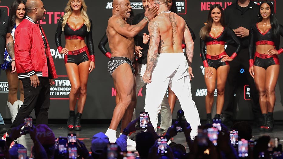 Mike Tyson slaps Jake Paul as they face off during their ceremonial weigh-in at The Pavilion at Toyota Music Factory on November 14, 2024 in Irving, Texas. The two are scheduled to meet in a heavyweight bout on November 15 at AT&amp;T Stadium in Arlington, Texas. (Photo by Christian Petersen/Getty Images)