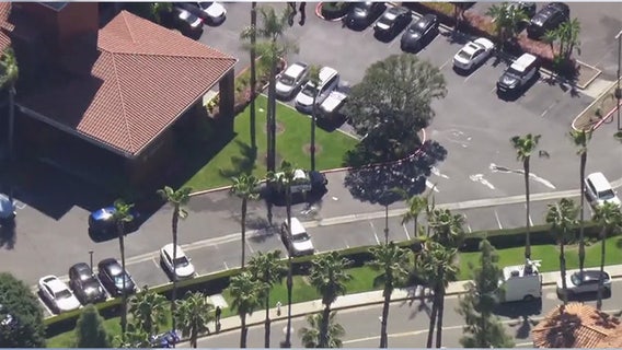 Mother taken into custody after 11-year-old son stabbed to death in Orange County hotel room