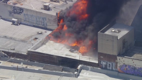 Workers, shoppers flee as fire spreads through busy commercial area in downtown LA