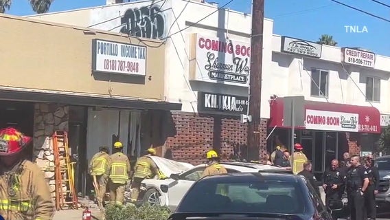 Man trapped after car crashes into building in Valley Glen