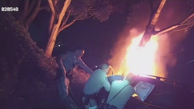 VIDEO: CHP officers rescue unconscious man from burning car