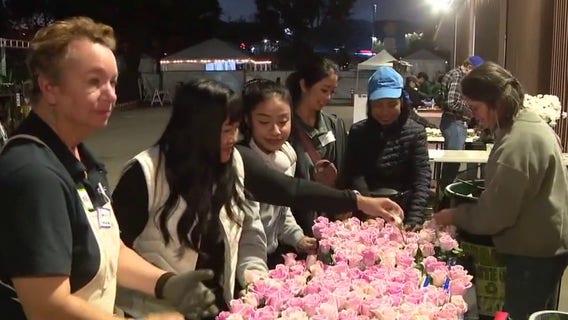 Volunteers working to get floats down the Rose Parade route, rain or shine