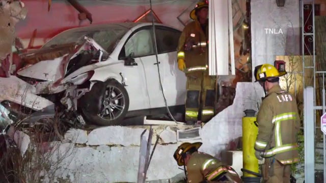 2 injured after Tesla plows into LA home near 5 Freeway