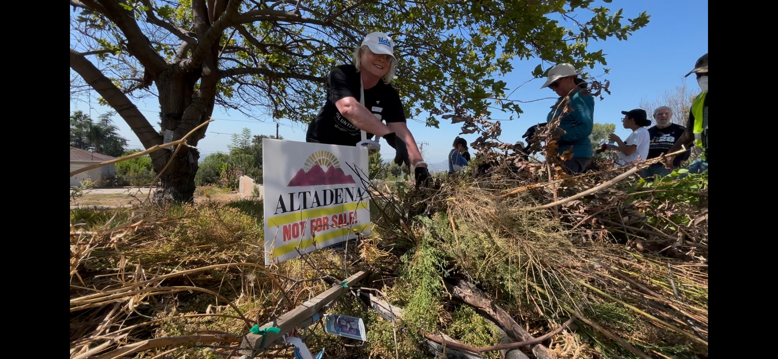 Volunteers clear brush in Altadena as 9/11 Day of Service events continue