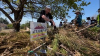Volunteers clear brush in Altadena as 9/11 Day of Service events continue