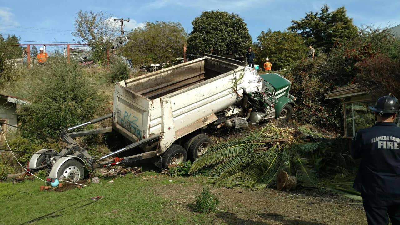 Dump truck slides into San Leandro home
