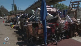 Officials begin to clear W. Oakland homeless encampment under 980