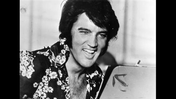 Fans walk silently, solemnly past Elvis' grave during vigil