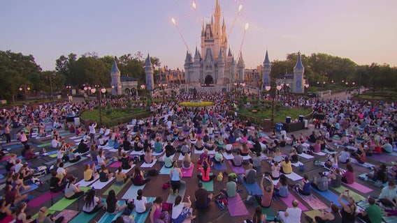Thousands of employees do yoga at Disney's Magic Kingdom