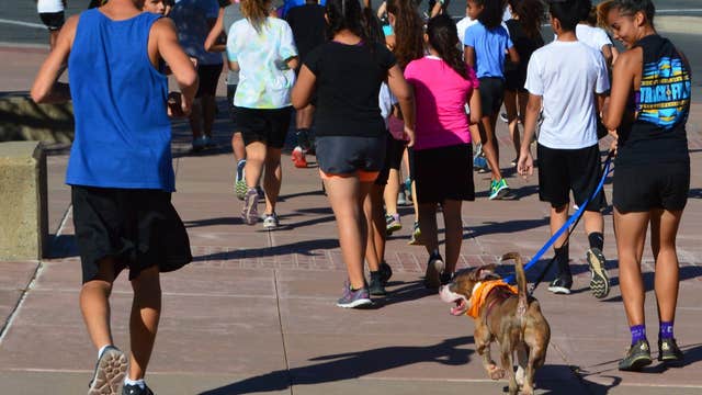 Antioch High School cross country team runs with shelter dogs