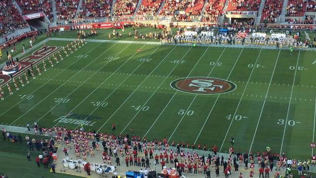 Colin Kaepernick sits during National Anthem