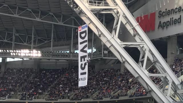 Dakota Access Pipeline protesters climb rafters at Vikings-Bears game