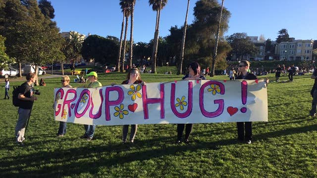 Large group hug takes place in Dolores Park