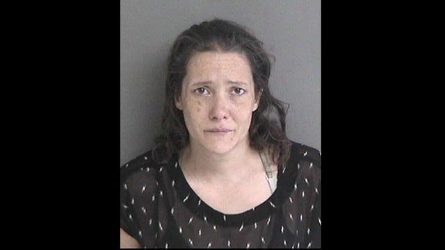 Woman allegedly fired flare at man, missed; started grass fire