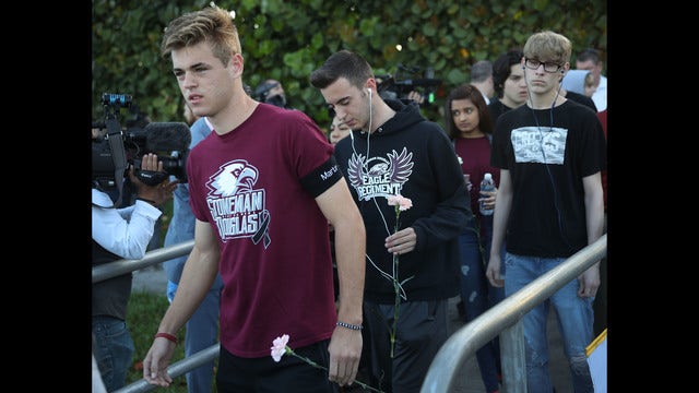 Hugs, tears and police: High school reopens after shooting