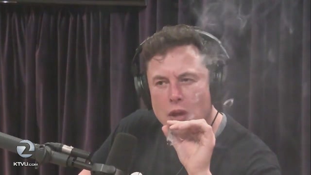 Tesla stock falls after CEO seen smoking what appears to be marijuana during YouTube interview