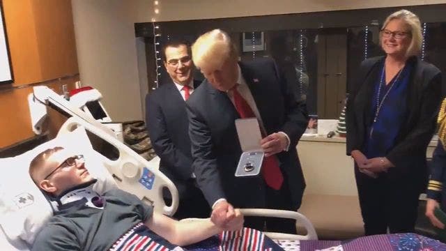 Trump awards Purple Heart to wounded soldier during holiday visit at Walter Reed