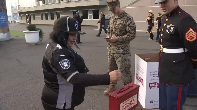 Marine Corps stations Toys for Tots bins at Raiders game