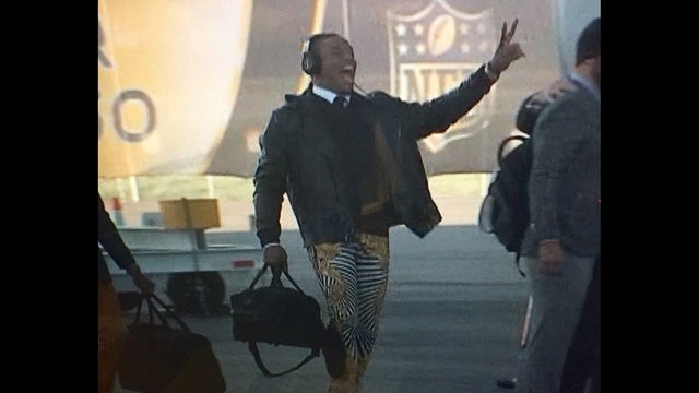 Cam Newton goes with zebra pants for trip to Super Bowl
