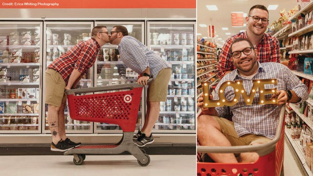 Couple kisses over shopping cart for engagement photo shoot inside Target