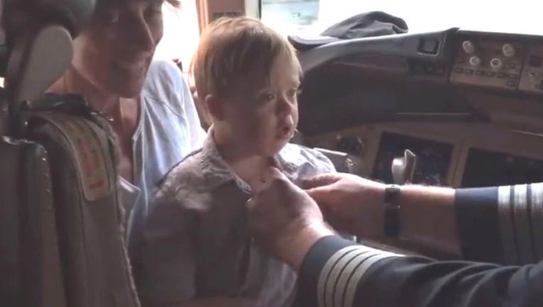 An American Airlines pilot, who retired after 35 years, gave his wings to a child with Down syndrome. (Joe Weis)