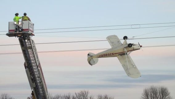 Pilot rescued after plane gets caught in power lines near Shakopee, Minn.