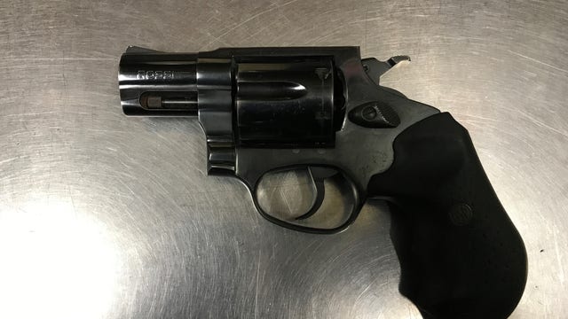 Man arrested after being found asleep in his vehicle with gun on his lap