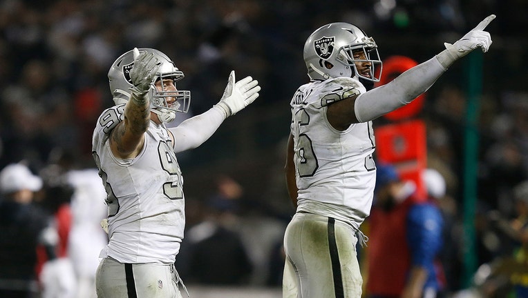 OAKLAND, CALIFORNIA - NOVEMBER 07: Maxx Crosby #98 and Clelin Ferrell #96 of the Oakland Raiders celebrate after an interception was thrown by Philip Rivers #17 of the Los Angeles Chargers late in the fourth quarter at RingCentral Coliseum on November 07, 2019 in Oakland, California. (Photo by Lachlan Cunningham/Getty Images)