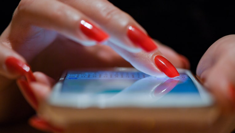 08 November 2019, Brandenburg, Sieversdorf: A woman with red fingernails writes a message on her smartphone. Photo: Patrick Pleul/dpa-Zentralbild/ZB (Photo by Patrick Pleul/picture alliance via Getty Images)