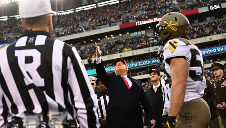 US President Donald Trump tosses the coin before the Army v. Navy American Football game in Philadelphia on December 14, 2019.