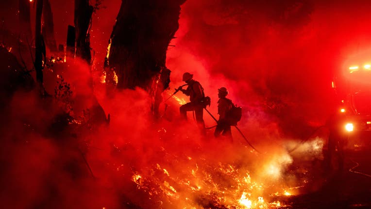 TOPSHOT - Firefighters work to control flames from a backfire during the Maria fire in Santa Paula, California on November 1, 2019. (Photo by Josh Edelson / AFP) (Photo by JOSH EDELSON/AFP via Getty Images)