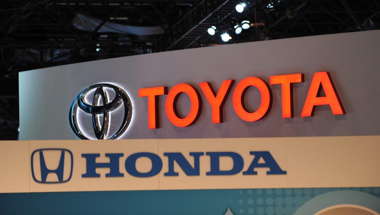 b3ec0a68-The logos for Toyota and Honda are seen at the New York International Auto Show in New York.