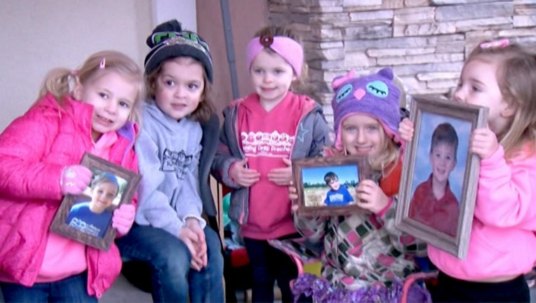 Preschoolers in Jasper's class pose during their hot cocoa stand fundraiser that raised money for Jasper's ongoing chemotherapy.