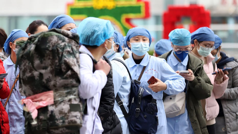 Medical personnel on a mission to help the COVID-19 patients in Hubei province wait to get onboard the express train leaving Nanchang city in central China's Jiangxi province on Feb. 13, 2020. (Photo credit: Feature China/Barcroft Media via Getty Images)