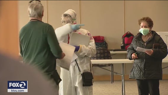 Wisconsin voters wait for hours, others stay home amid virus