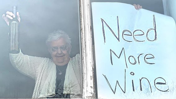 Quarantined grandma with 'Need More Wine' sign goes viral