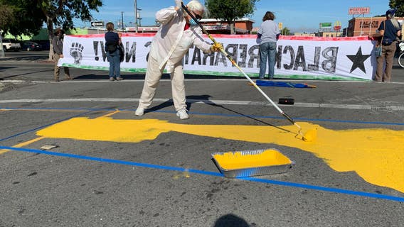 Artists paint powerful message across Richmond roadway demanding unity, change
