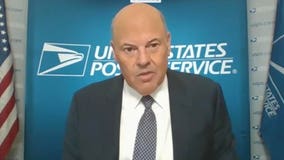 Postmaster says election mail will go through despite cuts