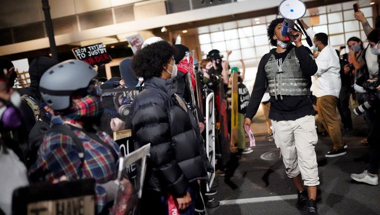 FILE - A crowd of a few hundred peaceful protester march past the Edith Green - Wendell Wyatt Federal Building in the early morning on August 2, 2020 in Portland, Oregon.