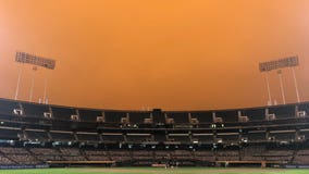 Smoke from wildfires creates eerie baseball scene in California