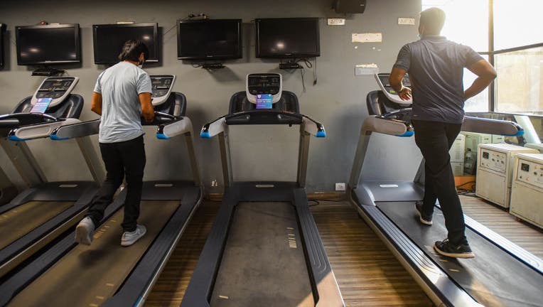 An image taken Sept. 14, 2020 shows two people running on treadmills inside a gym in New Delhi, India. (Photo by Amal KS/Hindustan Times via Getty Images