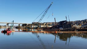 Crews work to limit petroleum spill from sinking barge in Petaluma