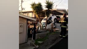 Car crashes into residential carport, goes over embankment