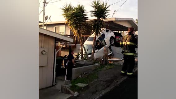 Car crashes into residential carport, goes over embankment